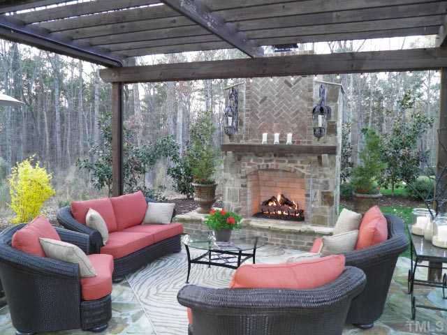 421 Rensford Place Cary, NC 27513 - Photo 22 of 25 a outdoor living space with furniture and a fireplace