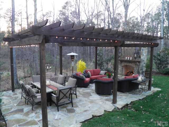 421 Rensford Place Cary, NC 27513 - Photo 23 of 25 a view of a patio with couches a table and chairs with a barbeque grill and a yard
