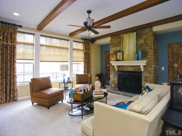 421 Rensford Place Cary, NC 27513 - Photo 5 of 25 a living room with furniture and a fireplace