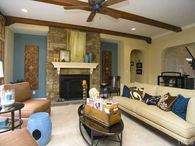 421 Rensford Place Cary, NC 27513 - Photo 6 of 25 a living room with furniture and a fireplace