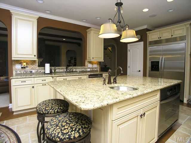 421 Rensford Place Cary, NC 27513 - Photo 7 of 25 a kitchen with a refrigerator and a sink