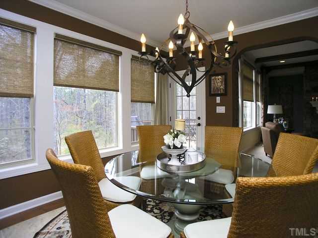 421 Rensford Place Cary, NC 27513 - Photo 9 of 25 a dining room with furniture a large window and a chandelier