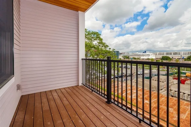 a view of a balcony with wooden floor
