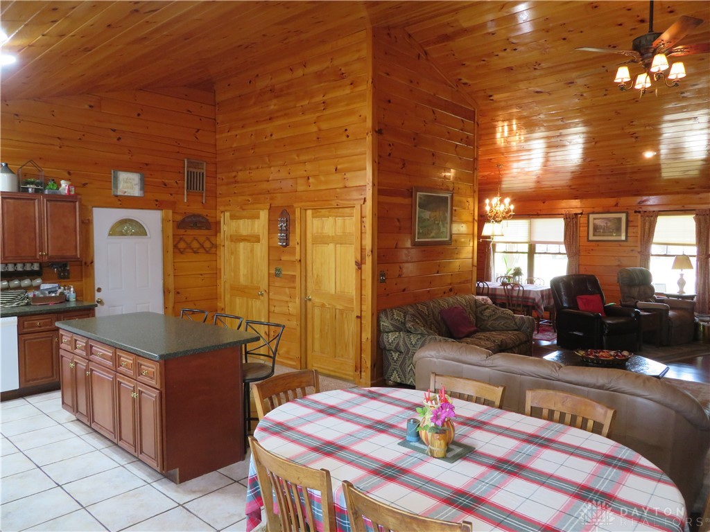748 Inlow Avenue Peebles, OH 45660 - Photo 61 of 61 This inviting interior features expansive wood paneling, an open floorplan, and abundant natural light.