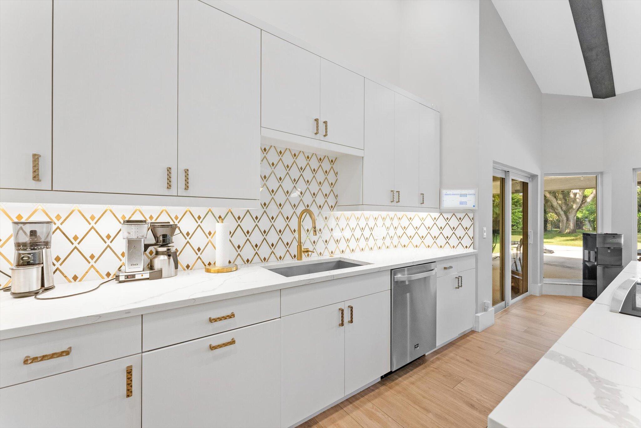 4429 Woodfield Boulevard Boca Raton, FL 33434 - Photo 20 of 61 a spacious bathroom with a sink and a mirror