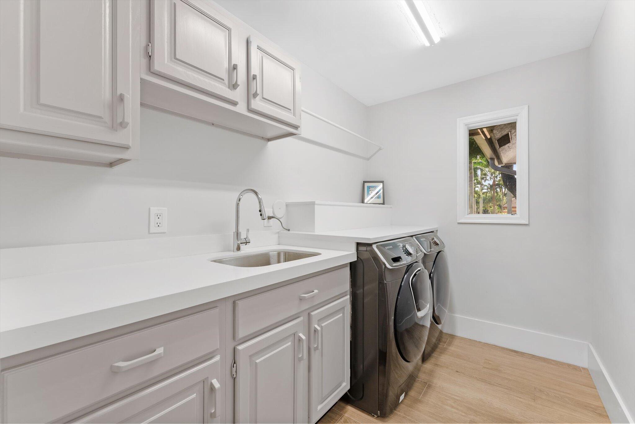 4429 Woodfield Boulevard Boca Raton, FL 33434 - Photo 36 of 61 a utility room with cabinets