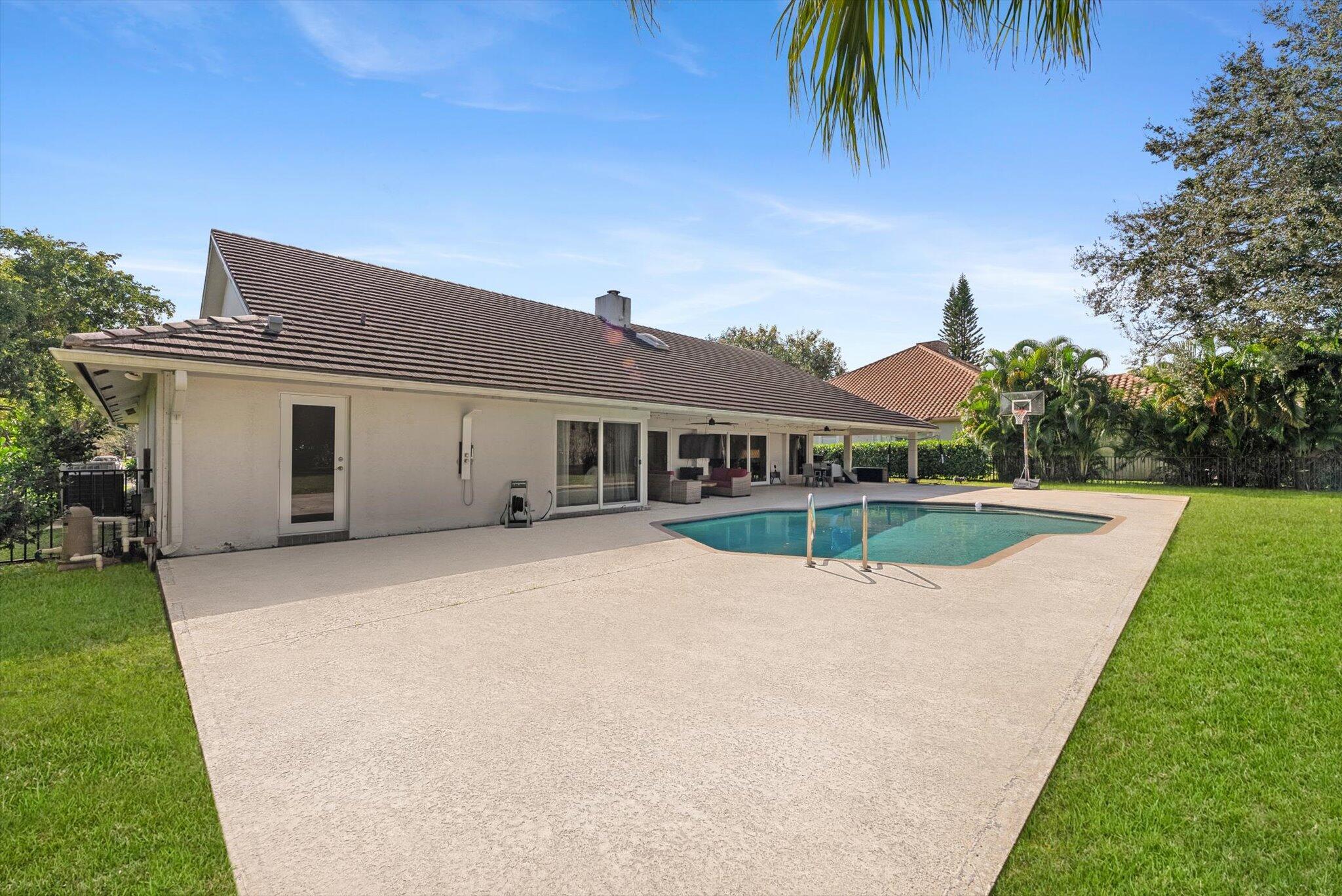 4429 Woodfield Boulevard Boca Raton, FL 33434 - Photo 43 of 61 a view of a house with a swimming pool