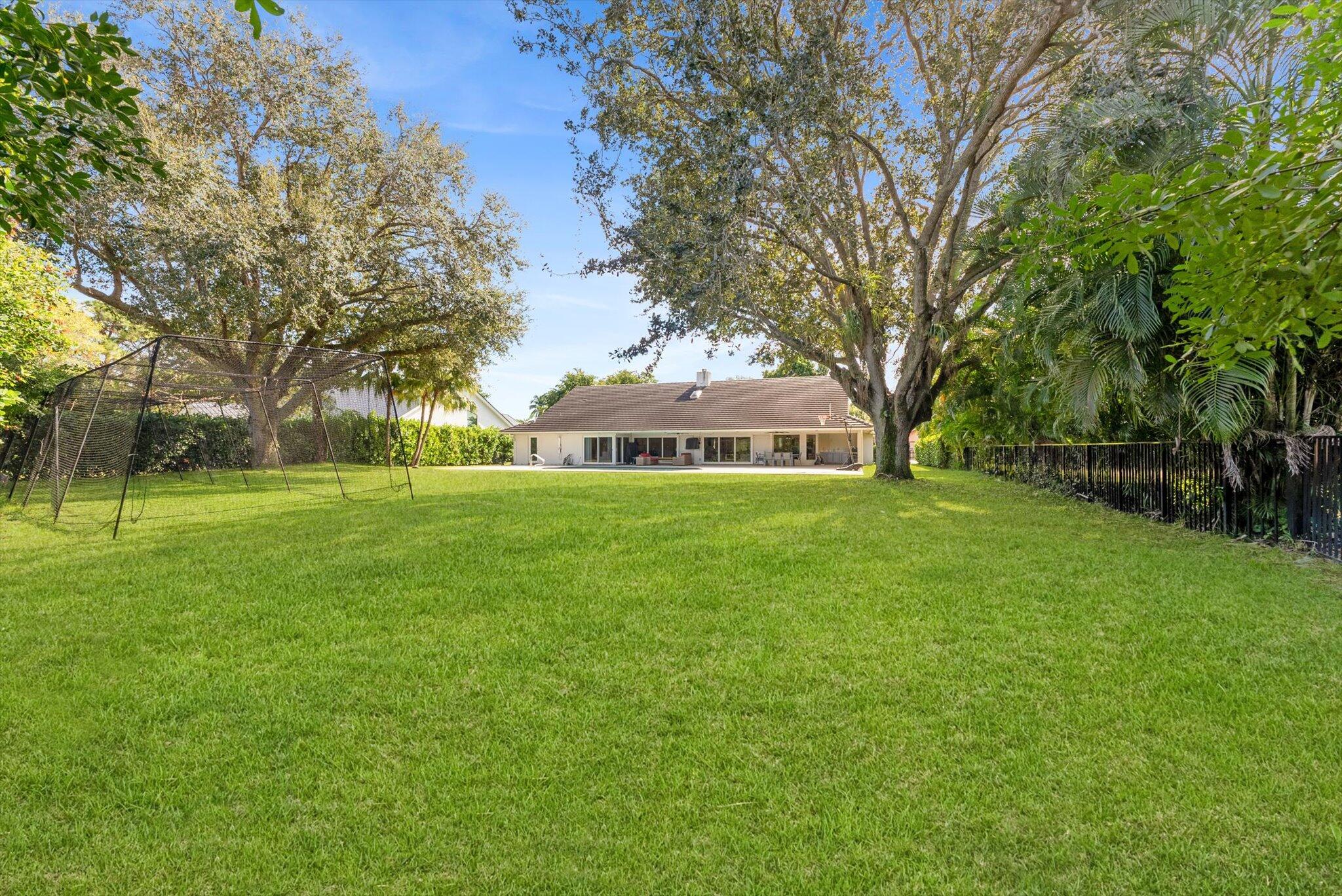 4429 Woodfield Boulevard Boca Raton, FL 33434 - Photo 45 of 61 a front view of a house with garden