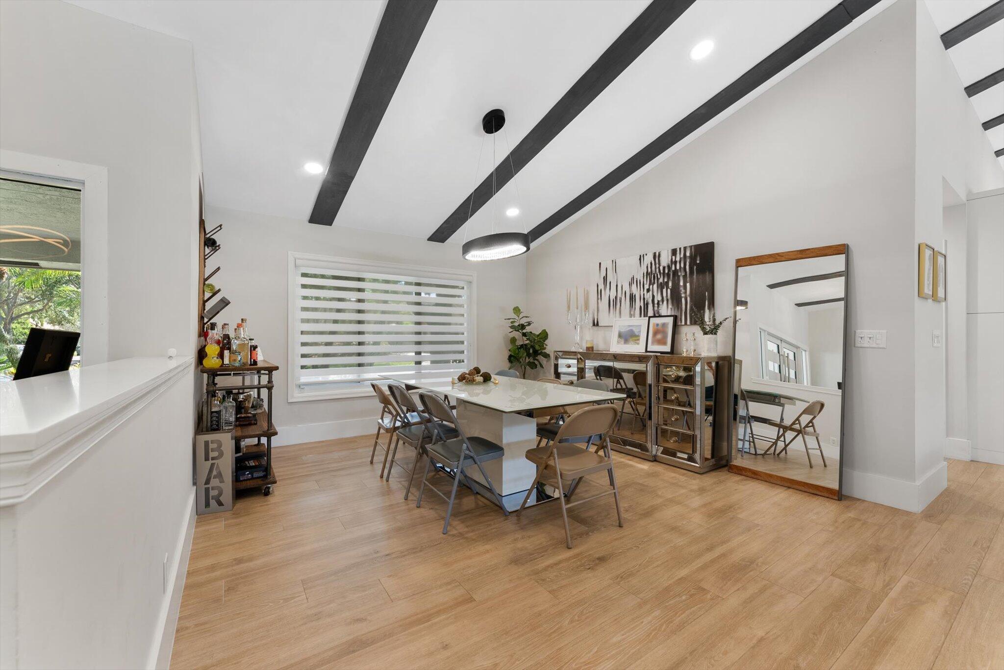 4429 Woodfield Boulevard Boca Raton, FL 33434 - Photo 7 of 61 a dining room with furniture and wooden floor