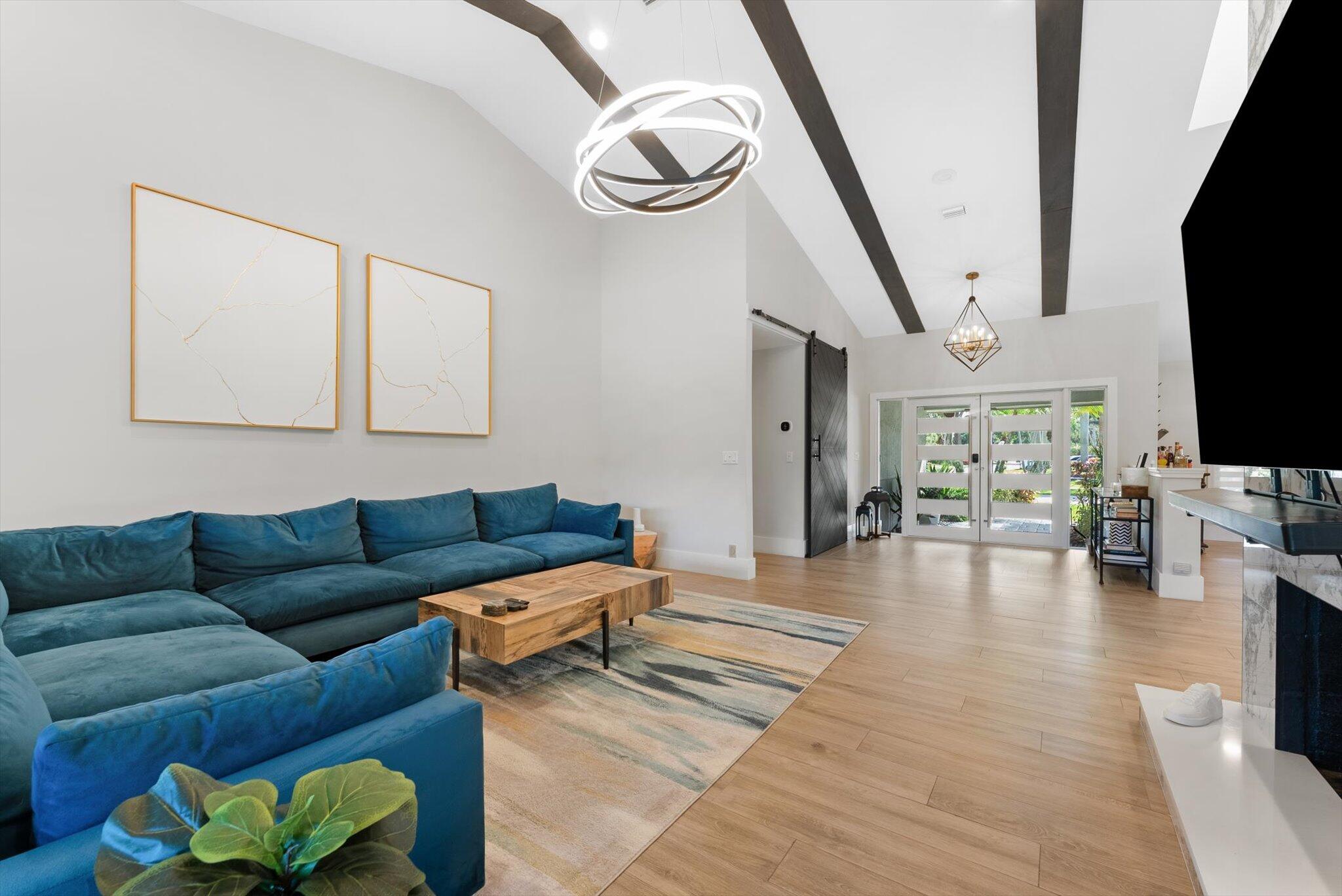 4429 Woodfield Boulevard Boca Raton, FL 33434 - Photo 10 of 61 a living room with furniture and a flat screen tv