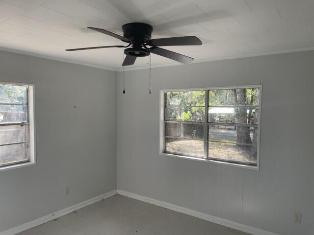 118 Peach Tree Street Paxton, FL 32567 - Photo 15 of 34 an empty room with a window and a fan