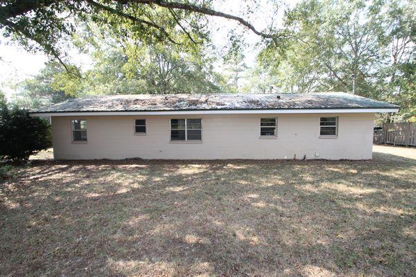 118 Peach Tree Street Paxton, FL 32567 - Photo 20 of 34 a house view with a backyard space
