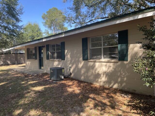 118 Peach Tree Street Paxton, FL 32567 - Photo 2 of 34 a front view of a house with a yard