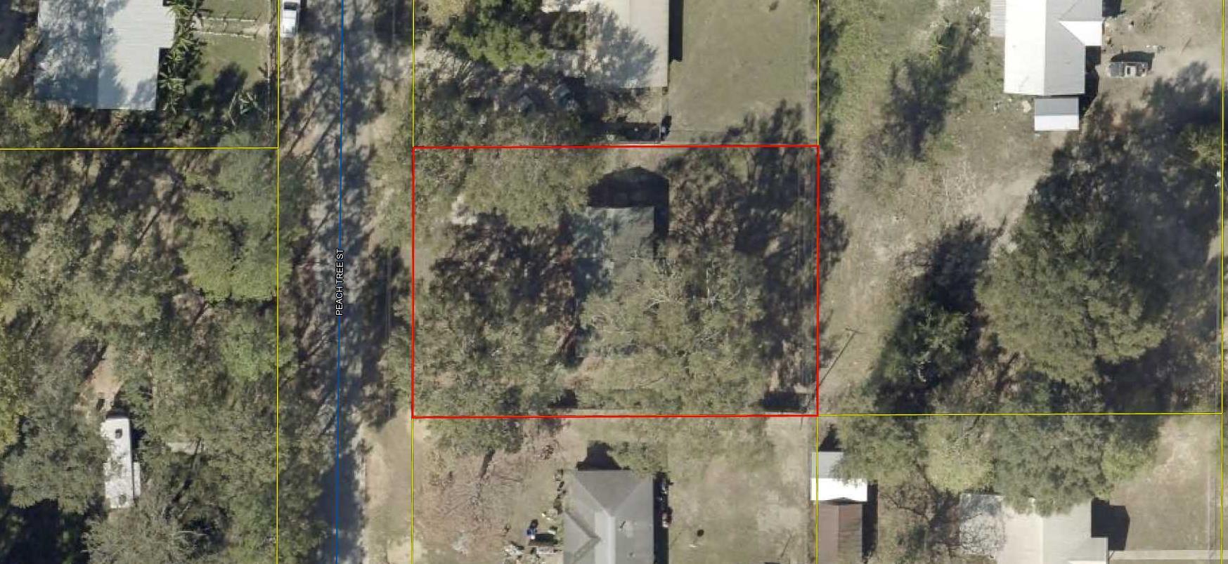 118 Peach Tree Street Paxton, FL 32567 - Photo 23 of 33 a view of a houses with a small yard