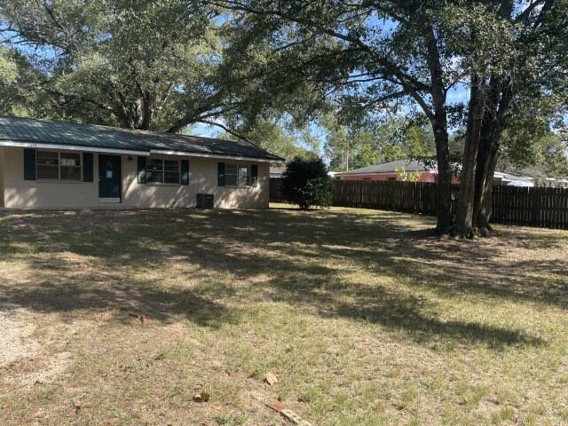 118 Peach Tree Street Paxton, FL 32567 - Photo 5 of 34 a view of a house with a tree in the background