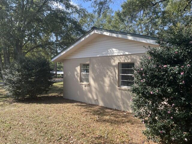 118 Peach Tree Street Paxton, FL 32567 - Photo 9 of 34 a house with trees in the background