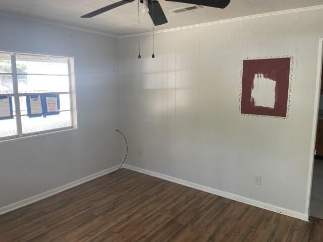 118 Peach Tree Street Paxton, FL 32567 - Photo 10 of 34 an empty room with wooden floor and windows