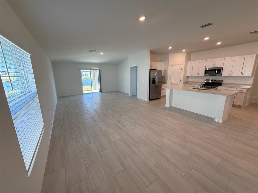 12434 Radiant Crystal Rose Place Parrish, FL 34219 - Photo 4 of 39 a view of kitchen with sink and wooden floor