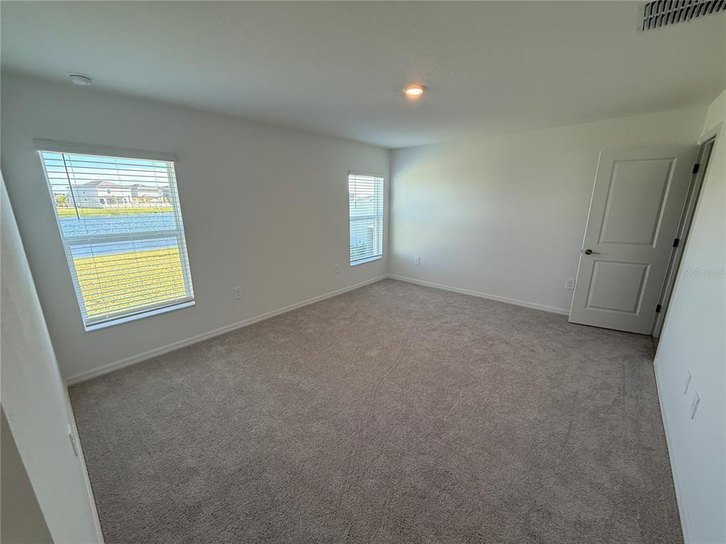 12434 Radiant Crystal Rose Place Parrish, FL 34219 - Photo 8 of 39 a view of an empty room with a window