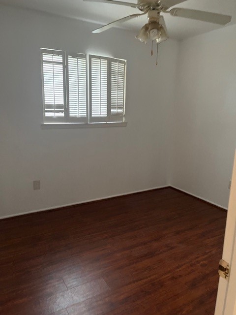 10923 Concho Street Houston, TX 77072 - Photo 3 of 6 a view of an empty room with wooden floor and a window