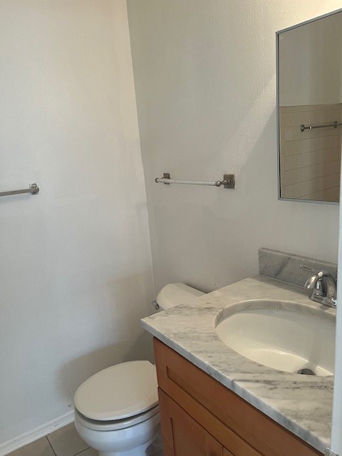 10923 Concho Street Houston, TX 77072 - Photo 6 of 6 a bathroom with a granite countertop toilet and sink