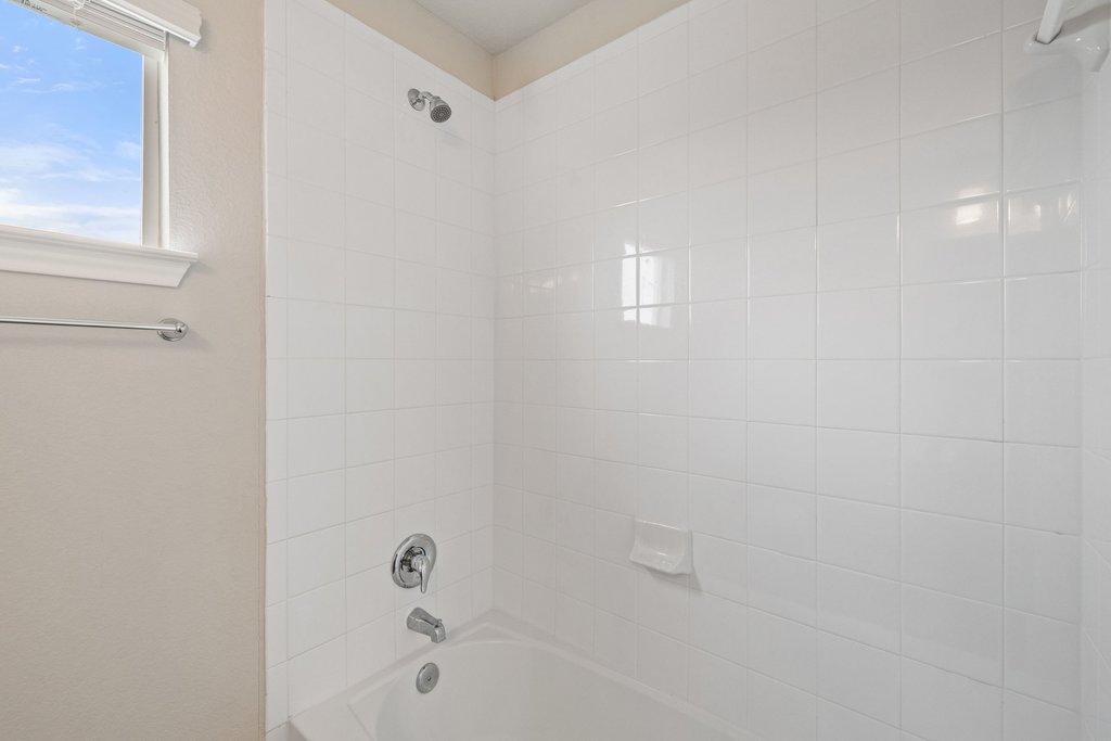 102 Ashford Way Georgetown, TX 78626 - Photo 20 of 28 A well-lit full bath with bright white tile surround offers a clean, inviting space.