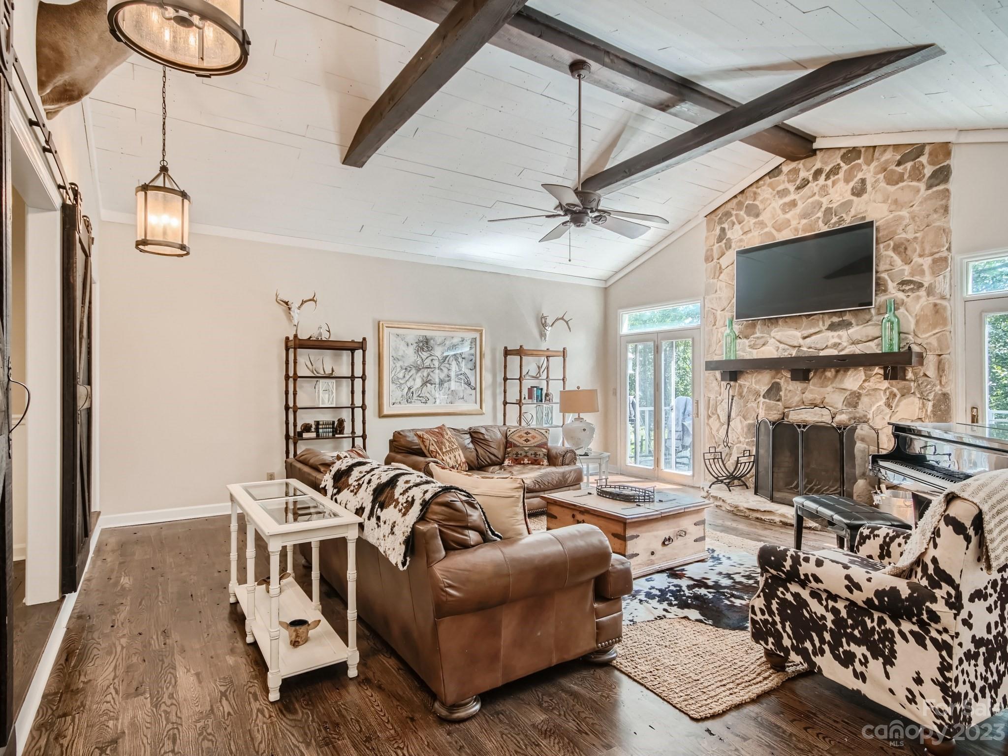 a living room with furniture a flat screen tv and a fireplace