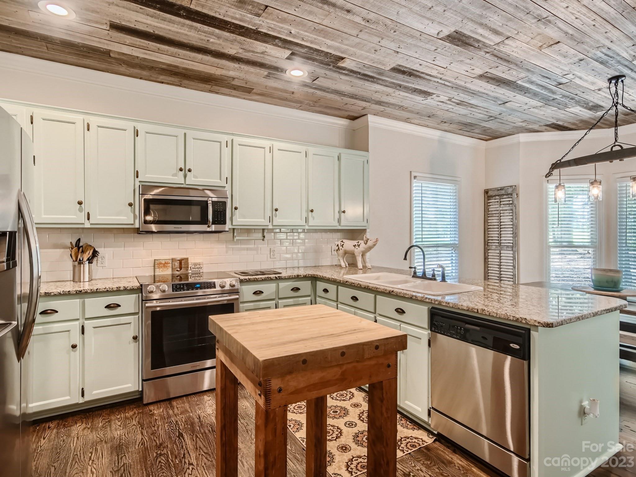 1815 Rock Rest Road Wingate, NC 28174 - Photo 11 of 27 a kitchen with a sink a stove and cabinets