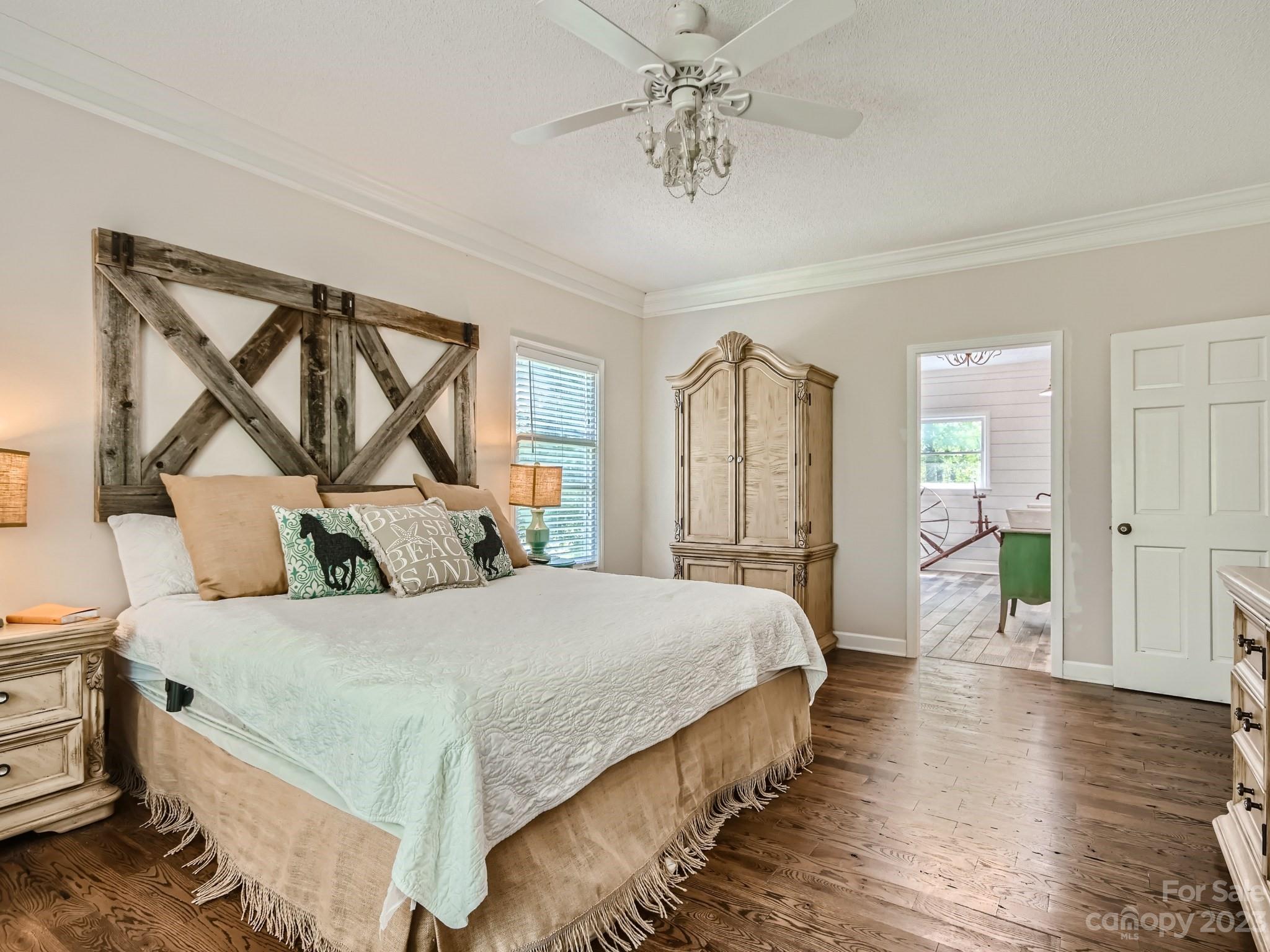 1815 Rock Rest Road Wingate, NC 28174 - Photo 14 of 27 a bedroom with a bed and a chandelier