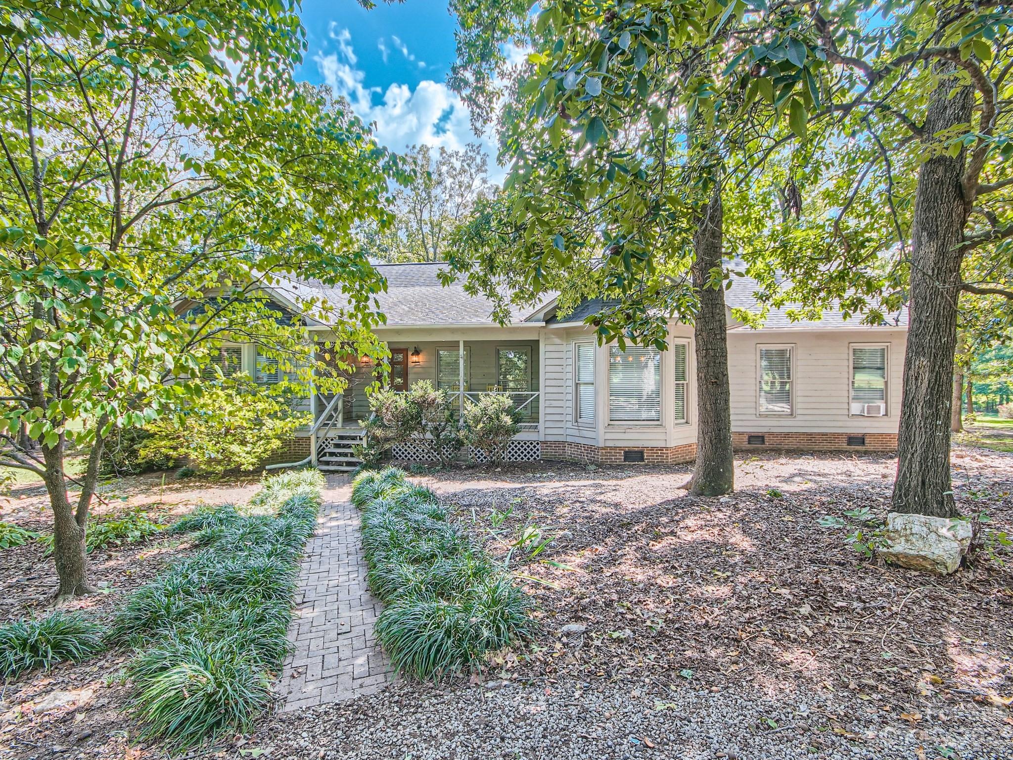 1815 Rock Rest Road Wingate, NC 28174 - Photo 2 of 27 a house that has tree in front of it