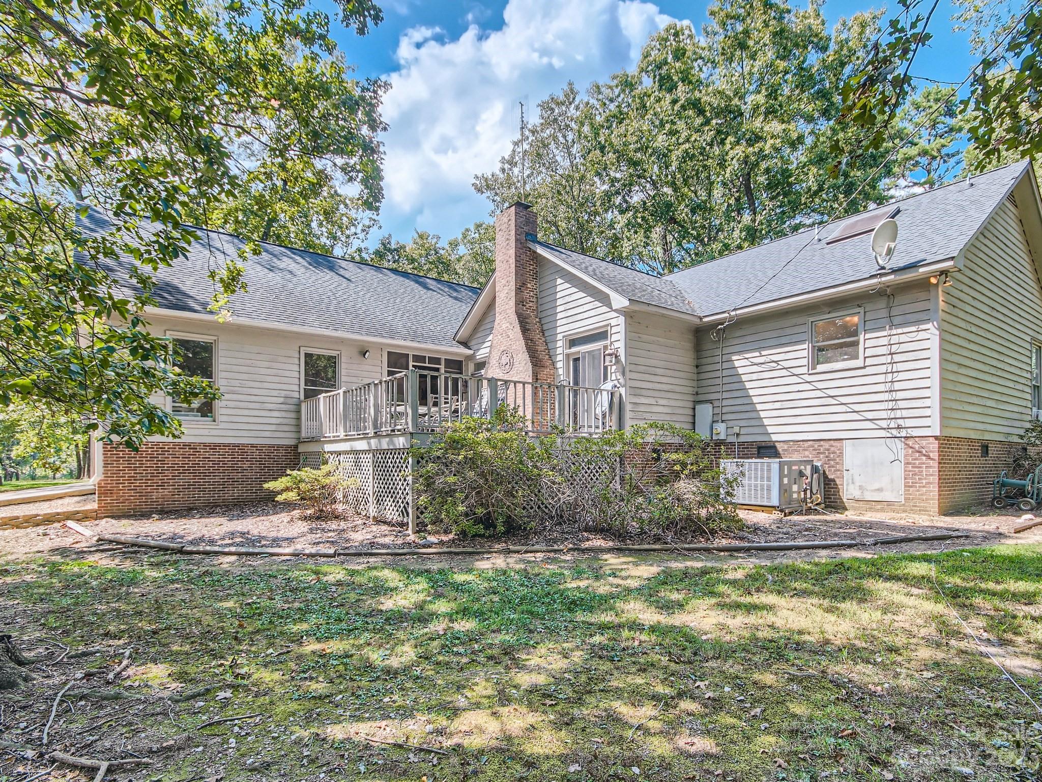 1815 Rock Rest Road Wingate, NC 28174 - Photo 24 of 27 a front view of a house with a yard and potted plants