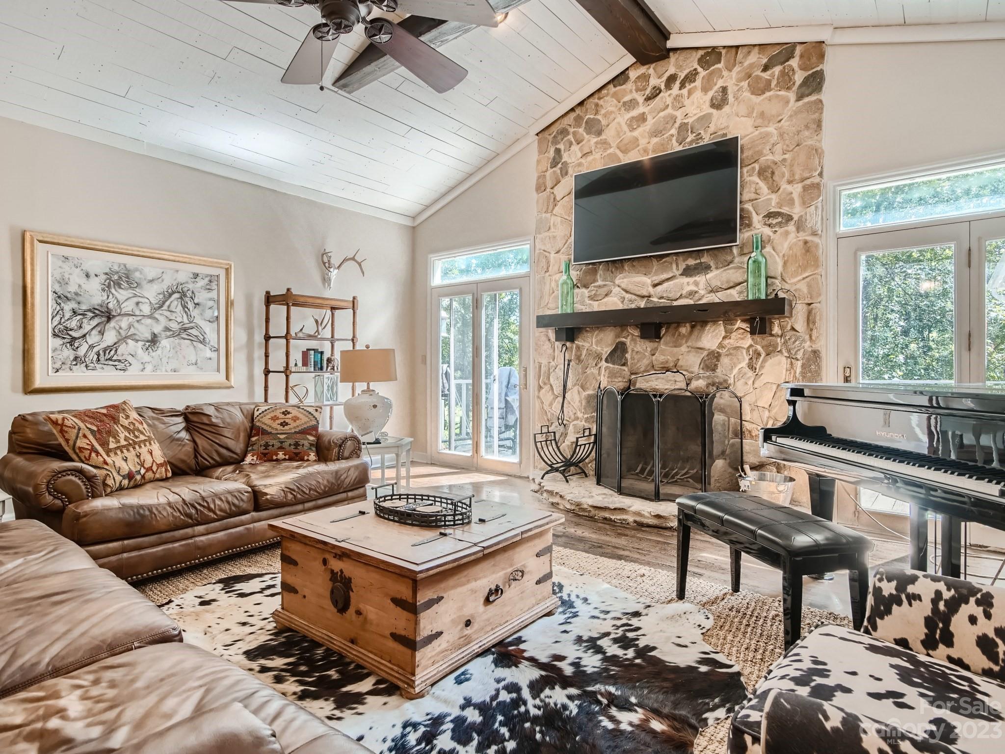 1815 Rock Rest Road Wingate, NC 28174 - Photo 6 of 27 a living room with furniture a fireplace and a flat screen tv