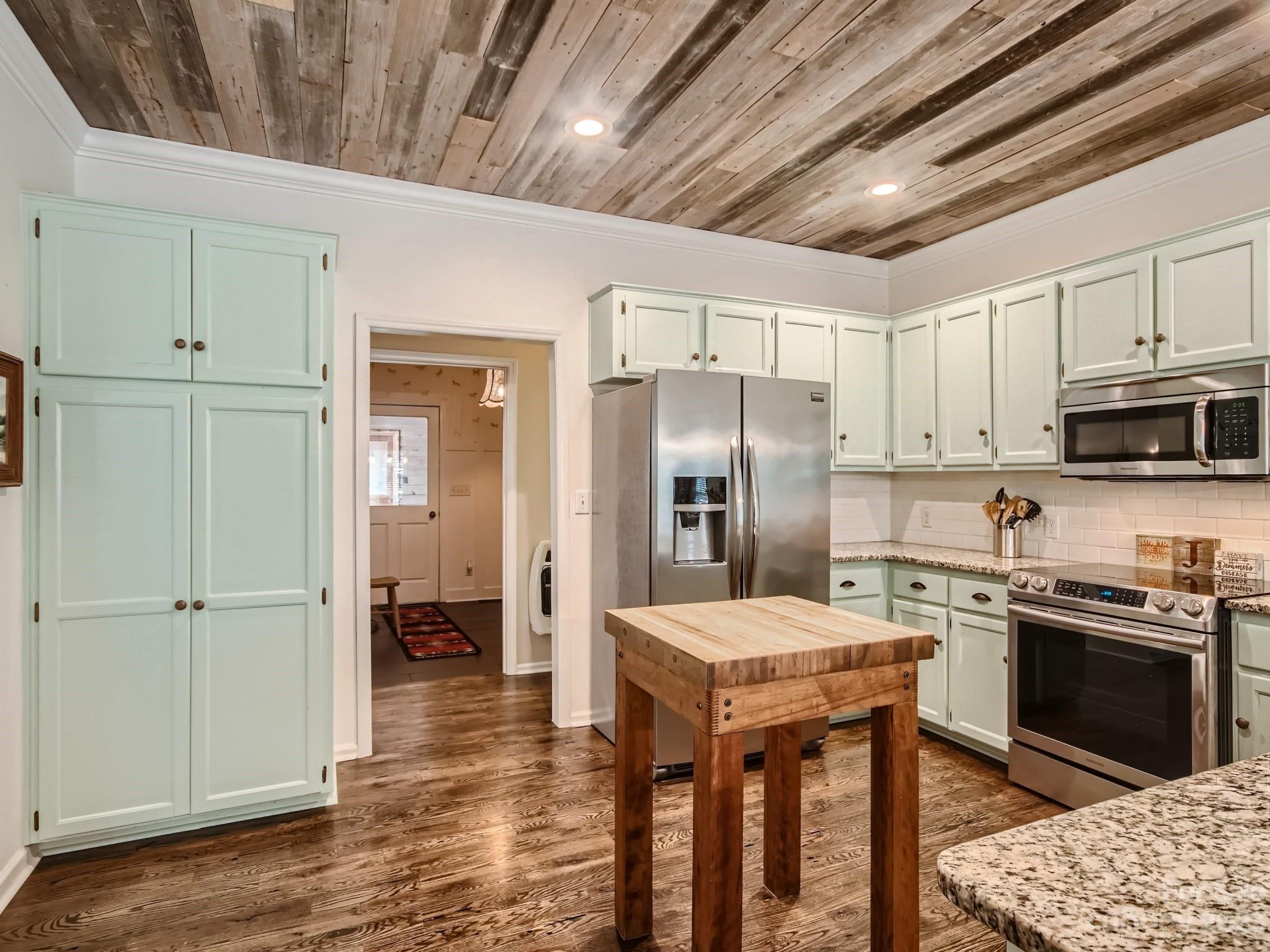 1815 Rock Rest Road Wingate, NC 28174 - Photo 10 of 27 a kitchen with stainless steel appliances kitchen island granite countertop a refrigerator a stove sink and cabinets