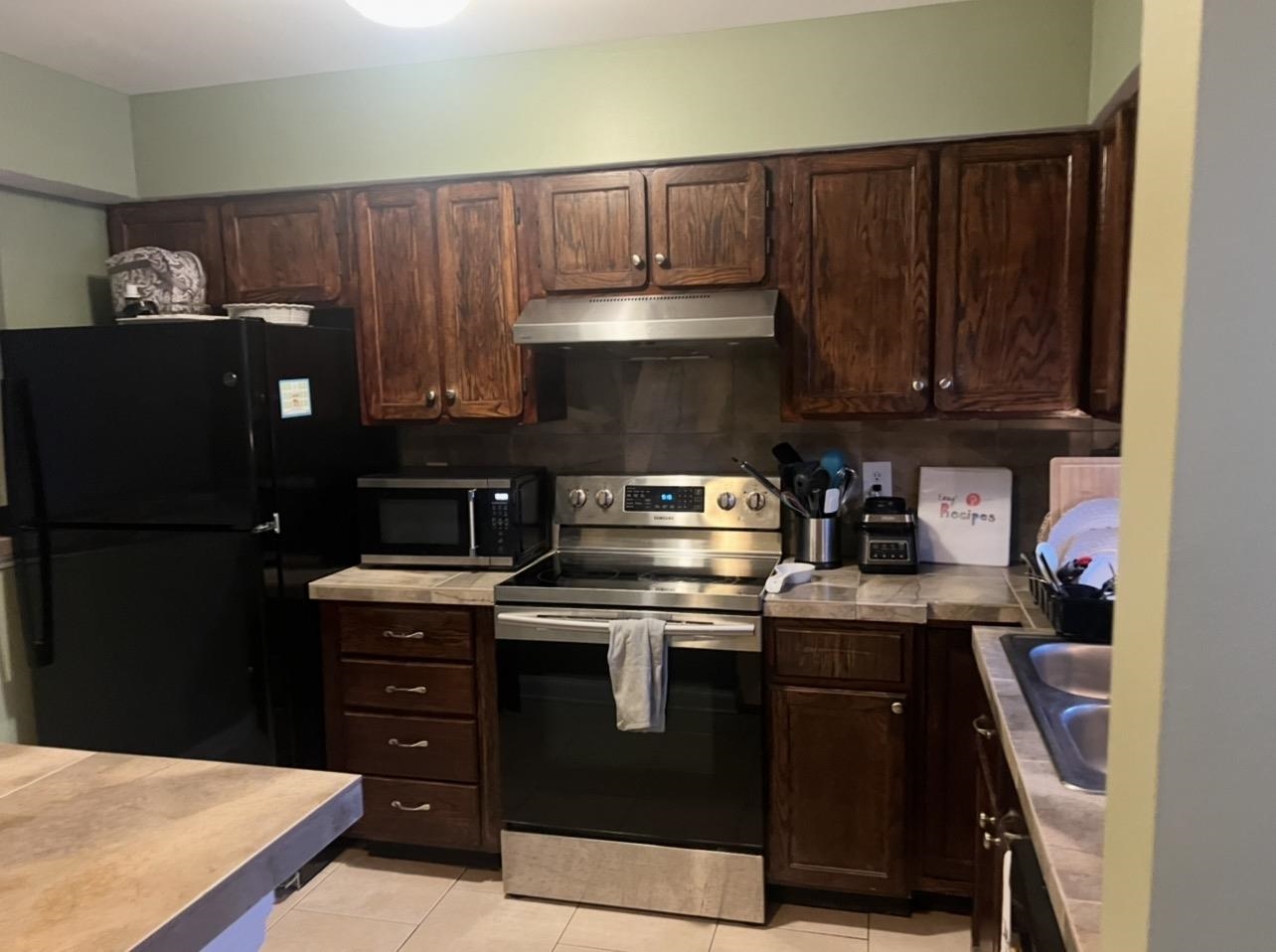 1025 Carolina Road, Unit O1 Conway, SC 29526 - Photo 4 of 18 Kitchen featuring stainless steel appliances, dark brown cabinetry, tile counters, and decorative backsplash