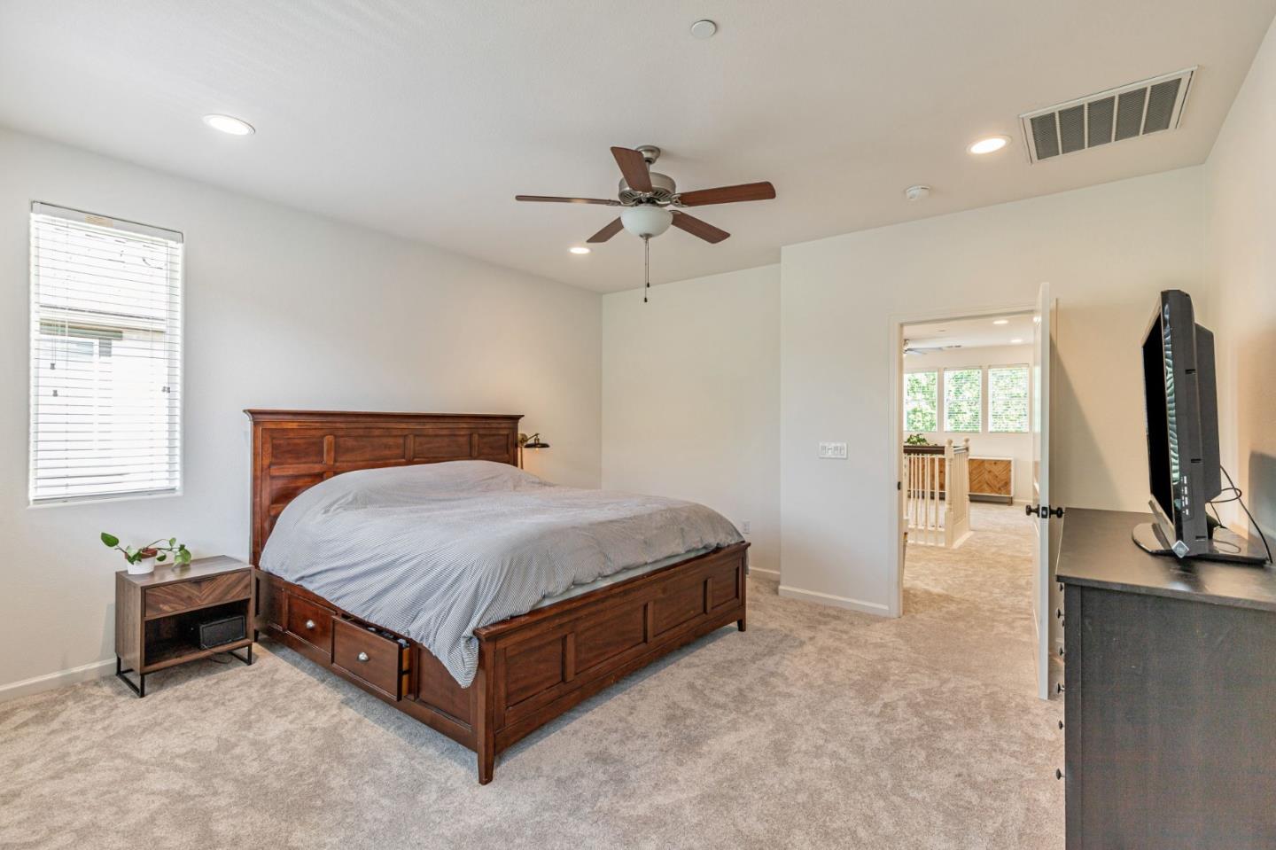 51 Koror Lane Gilroy, CA 95020 - Photo 22 of 50 a spacious bedroom with a bed and a flat tv screen on dresser