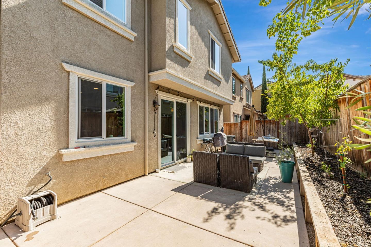 51 Koror Lane Gilroy, CA 95020 - Photo 36 of 50 a view of a patio with table and chairs potted plants and floor to ceiling window