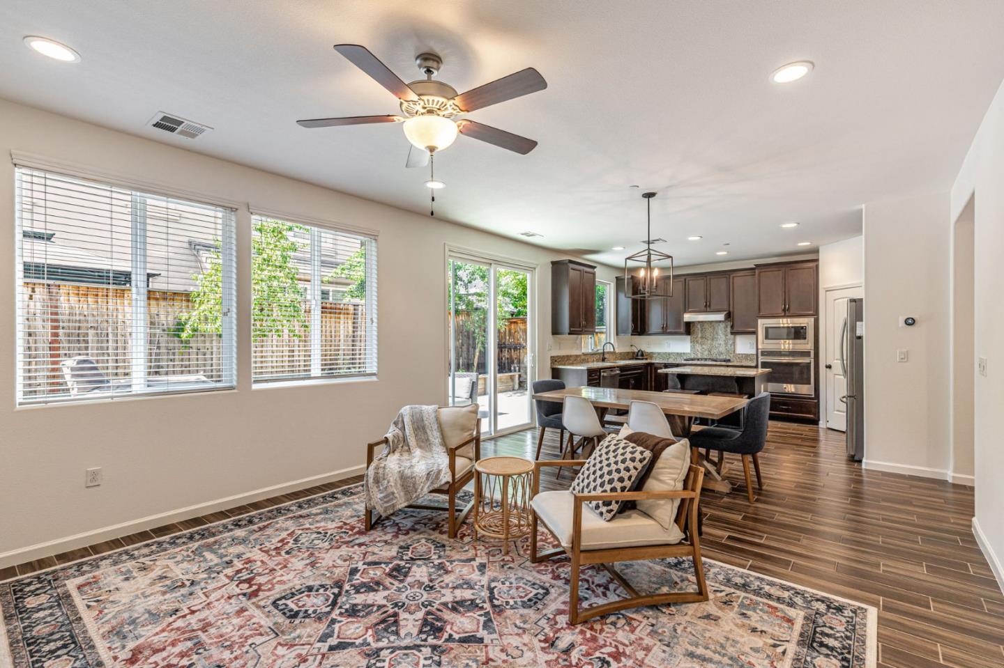 51 Koror Lane Gilroy, CA 95020 - Photo 6 of 50 a living room with a dining table and paintings on the wall with wooden floor