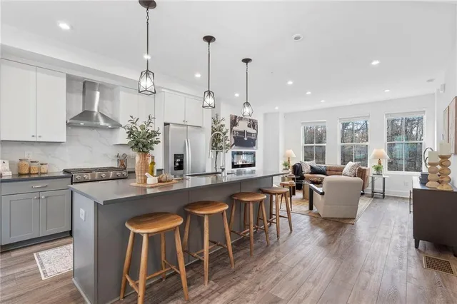 a large kitchen with a table and chairs