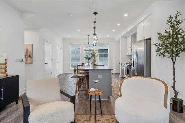 a living room with furniture a chandelier and a chandelier