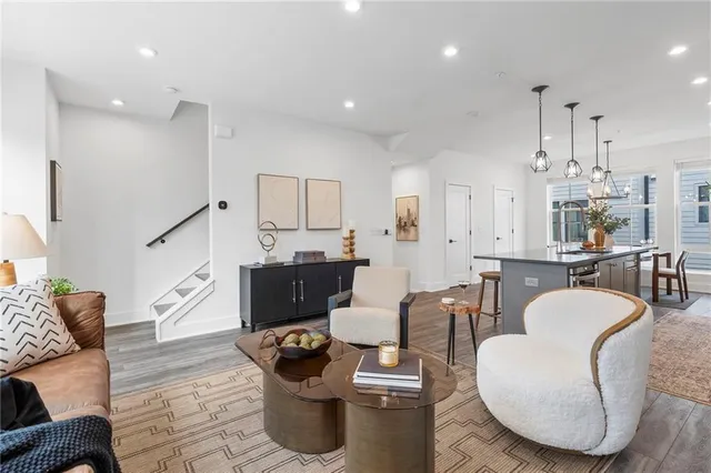 a living room with furniture a fireplace and kitchen view