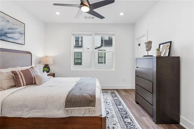 a bedroom with a large bed and a chandelier