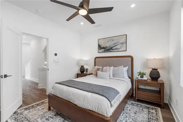 a bedroom with a bed and a painting on the wall