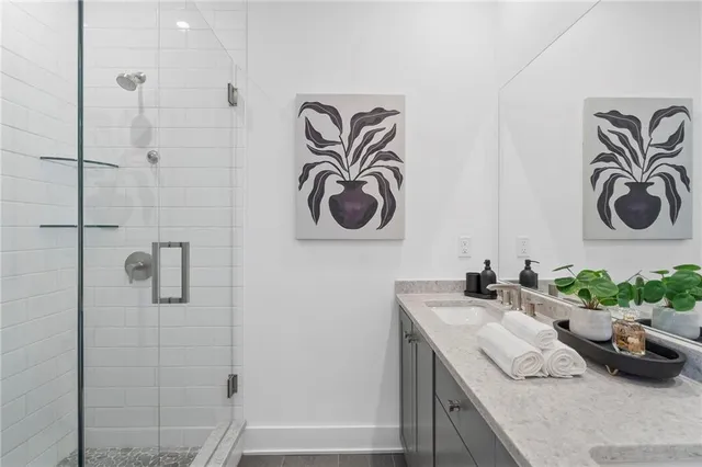a bathroom with a sink a mirror and shower