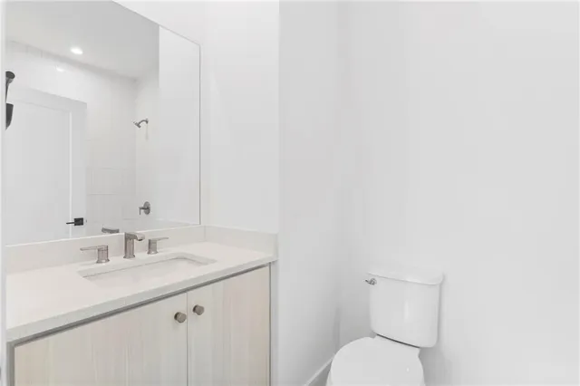a bathroom with a sink toilet and vanity