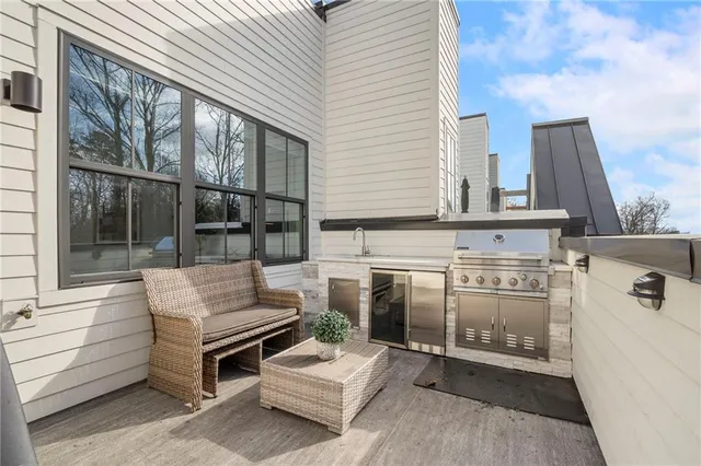 a view of a patio with couches table and chairs under an umbrella