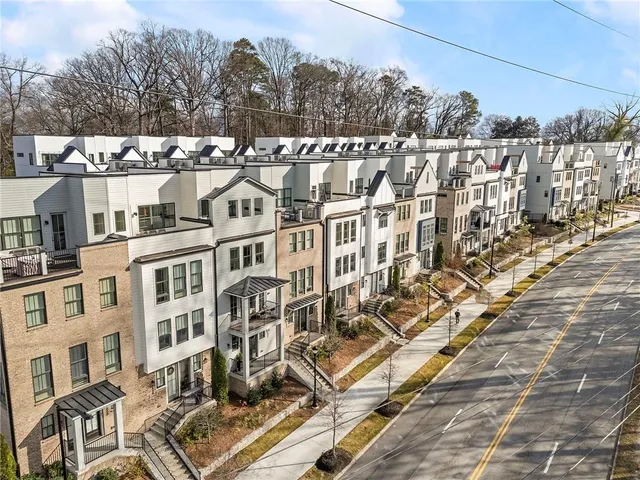 an aerial view of residential houses with outdoor space