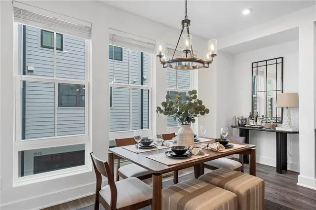 a view of a livingroom and dining room with furniture wooden floor and a chandelier