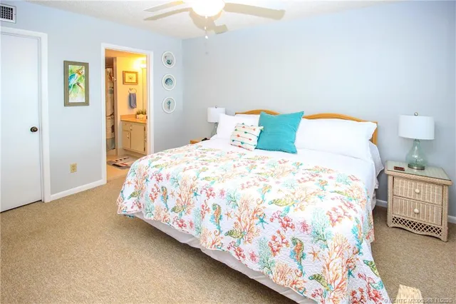 a bedroom with a bed and painting on the wall