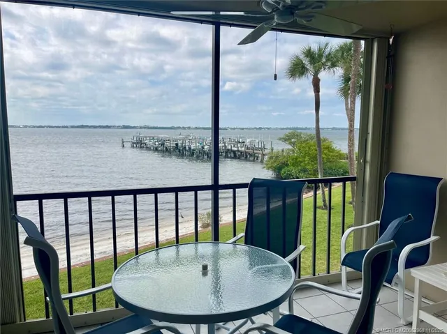a view of a balcony with a table and chairs