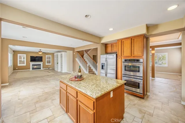 a kitchen with granite countertop sink and stove